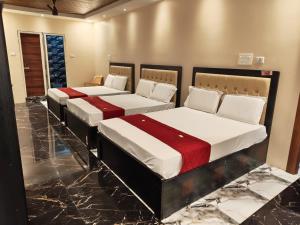 two beds in a room with marble floors at RCH Home Stay in Rāmeswaram