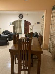 a dining room with a wooden table and chairs at Dragon beach in Dondra West