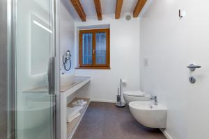 a bathroom with a sink and a toilet and a shower at Domus Al Concilio in Trento +26 photos