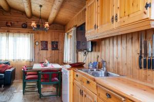 a kitchen with wooden cabinets and a sink at Rundetjødn 20 in Hol +13 photos