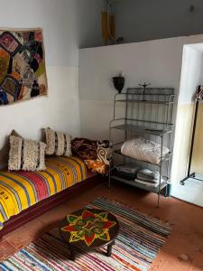 a living room with a couch and a shelf at 34 Degrés Sud in Mirleft