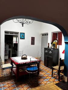 a dining room with a table and chairs in a room at 34 Degrés Sud in Mirleft