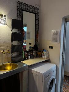 a kitchen with a washing machine and a sink at 34 Degrés Sud in Mirleft