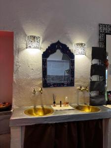 a bathroom with a yellow sink and a mirror at 34 Degrés Sud in Mirleft +20 photos