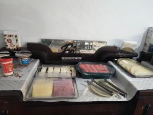 a kitchen counter with a stove top with food on it at Hotel XV in Piracicaba