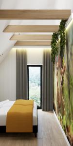 a bedroom with a bed and a large window at Prime - Event & Relax Resort in Jaszczurowa