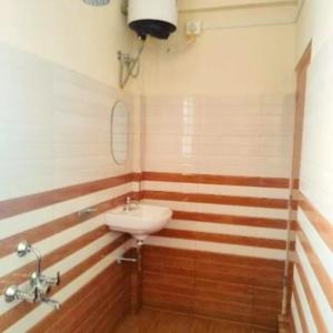 a bathroom with a sink and a mirror at Za Homestay in Cherrapunji +4 photos