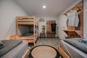 a room with two bunk beds and a closet at SURFinn Lisbon in Costa da Caparica +65 photos