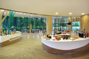 a large lobby with a food counter in a building at Ibis Styles Bogor Raya in Bogor