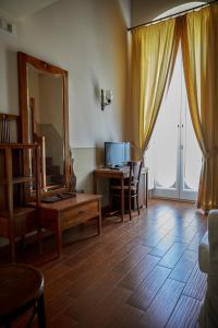 a living room with a large mirror and a table at GOLA Dimora storica in Cerignola