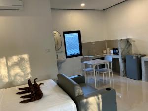 a room with a bed with a monkey sitting on it at Lanta Beautiful beach house 1 in Phra Ae beach