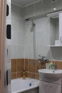 a bathroom with a shower and a sink and a tub at Apartment квартира Ярослава Мудрого in Kryvyi Rih
