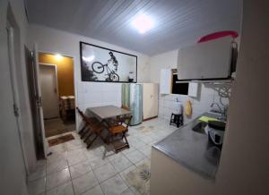 a kitchen with a table and a counter top at Pousada A Casa Barra do Riacho in Aracruz +50 photos