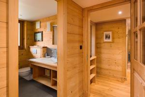 a wooden bathroom with a sink and a toilet at Chalet François in Champéry +90 photos