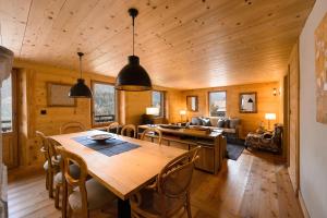 a dining room and living room with a table and chairs at Chalet François in Champéry