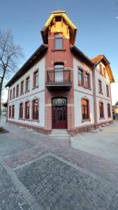 a large brick building with a balcony on top of it at JOSEFS Gasthaus Sibille in Schlangen
