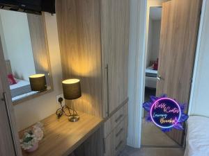 a bedroom with a desk with a sign on it at Goaty Lodge - 2 The Green in Tattershall +15 photos