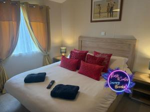 a bedroom with a large bed with a sign on it at Goaty Lodge - 2 The Green in Tattershall