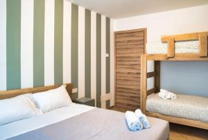 a bedroom with a bed and a bunk bed at El Surcinel – Alpine Design Home in Ballabio