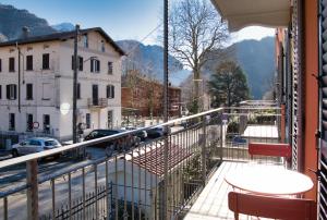 a balcony with a table and a view of a street at El Surcinel – Alpine Design Home in Ballabio