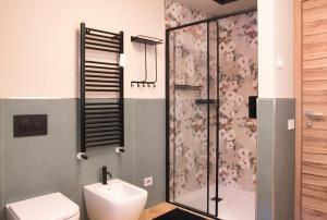 a bathroom with a shower and a toilet at El Surcinel – Alpine Design Home in Ballabio +43 photos