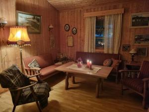 a living room with a table with a candle on it at Idyllic house on a farm in Steinkjer