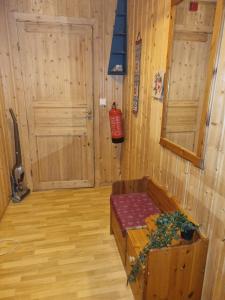 a room with a bed in a room with wooden walls at Idyllic house on a farm in Steinkjer