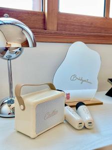 a toaster and remote controls sitting on a counter at 강릉 44평 복층 독채 시아스테이 Gangneung Sia Stay in Gangneung