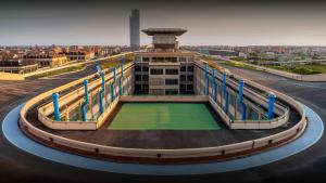 a building with a green lawn in front of it at Casa Torino Lingotto centro fiere, metro, Inalpi Arena,Centro Congressi, Ospedale Molinette, Politecnico in Turin