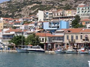 a group of boats docked in a harbor with buildings at Pythagorion Harbour Residence in Pythagoreio