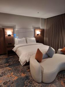 a hotel room with a large bed and a couch at ثريو thrio للشقق المخدومة in Riyadh +96 photos
