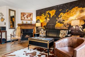 a living room with a couch and a map on the wall at Stylish 1BR Free Attraction Tix Views! in Gatlinburg