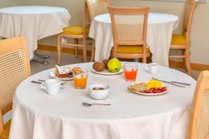 a table with breakfast foods and drinks on it at B&B HOTEL Bergamo Executive in San Paolo D'Argon