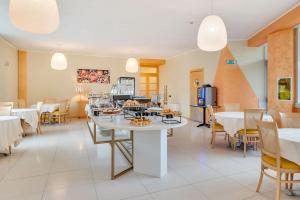 a restaurant with a table with food on it at B&B HOTEL Bergamo Executive in San Paolo D'Argon