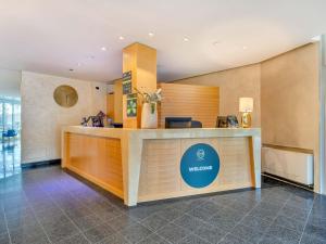 a lobby of a hotel with a reception desk at B&B HOTEL Bergamo Executive in San Paolo D'Argon +21 photos