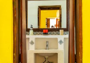 a bathroom with a sink and a mirror at Ella's Swahili Villa - Restored 1840s Heritage Home in Bagamoyo +80 photos
