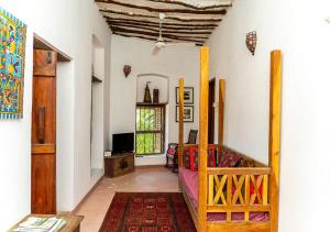 a room with a bedroom with a bed and a window at Ella's Swahili Villa - Restored 1840s Heritage Home in Bagamoyo