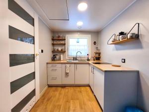 a kitchen with white cabinets and a sink at Domki Wetlina 21 in Wetlina +38 photos