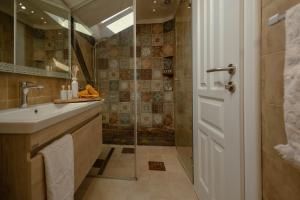 a bathroom with a sink and a shower at Apartments Salim in Sarajevo +24 photos