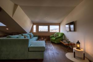 a living room with a couch and two chairs at Apartments Salim in Sarajevo