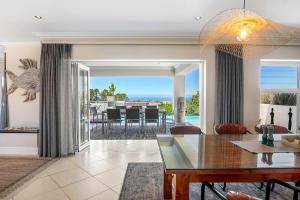 a dining room and living room with a view of the ocean at SL9 - Pezula Double Storey Luxury in Knysna