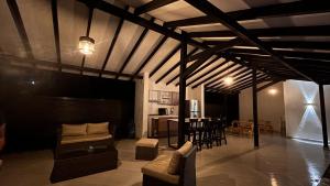 a living room with a couch and a table and chairs at Villa Serena Sopetran in Sopetrán