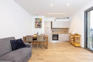a living room and kitchen with a couch and a table at La Strencia in Villa di Tirano