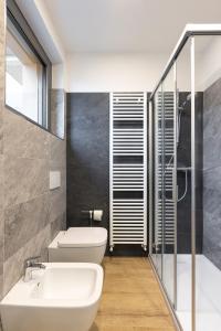 a bathroom with a white toilet and a sink at La Strencia in Villa di Tirano +51 photos