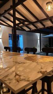 a large wooden table in a room with chairs at Villa Serena Sopetran in Sopetrán