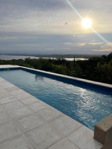 a swimming pool with a view of the ocean at Complejo DOS LUNAS in San Roque