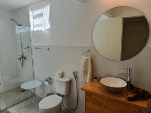 a bathroom with a toilet and a sink and a mirror at My Place Boutique Hotel in Puerto Iguazú +26 photos