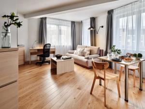 a living room with a table and a couch at Apartamenty Media Park in Warsaw