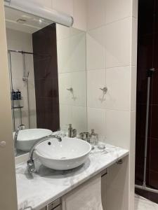 a bathroom with a sink and a mirror at Compass apartment in Tallinn +13 photos