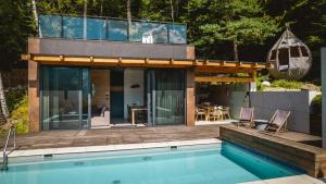 a house with a swimming pool next to a house at Niebo Beskidu in Brenna +52 photos